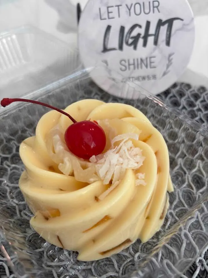 Before: dessert cup in plastic container with busy sign and textured backdrop